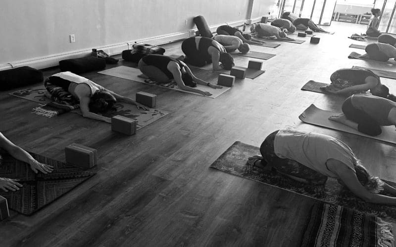 Group yoga class practicing child's pose