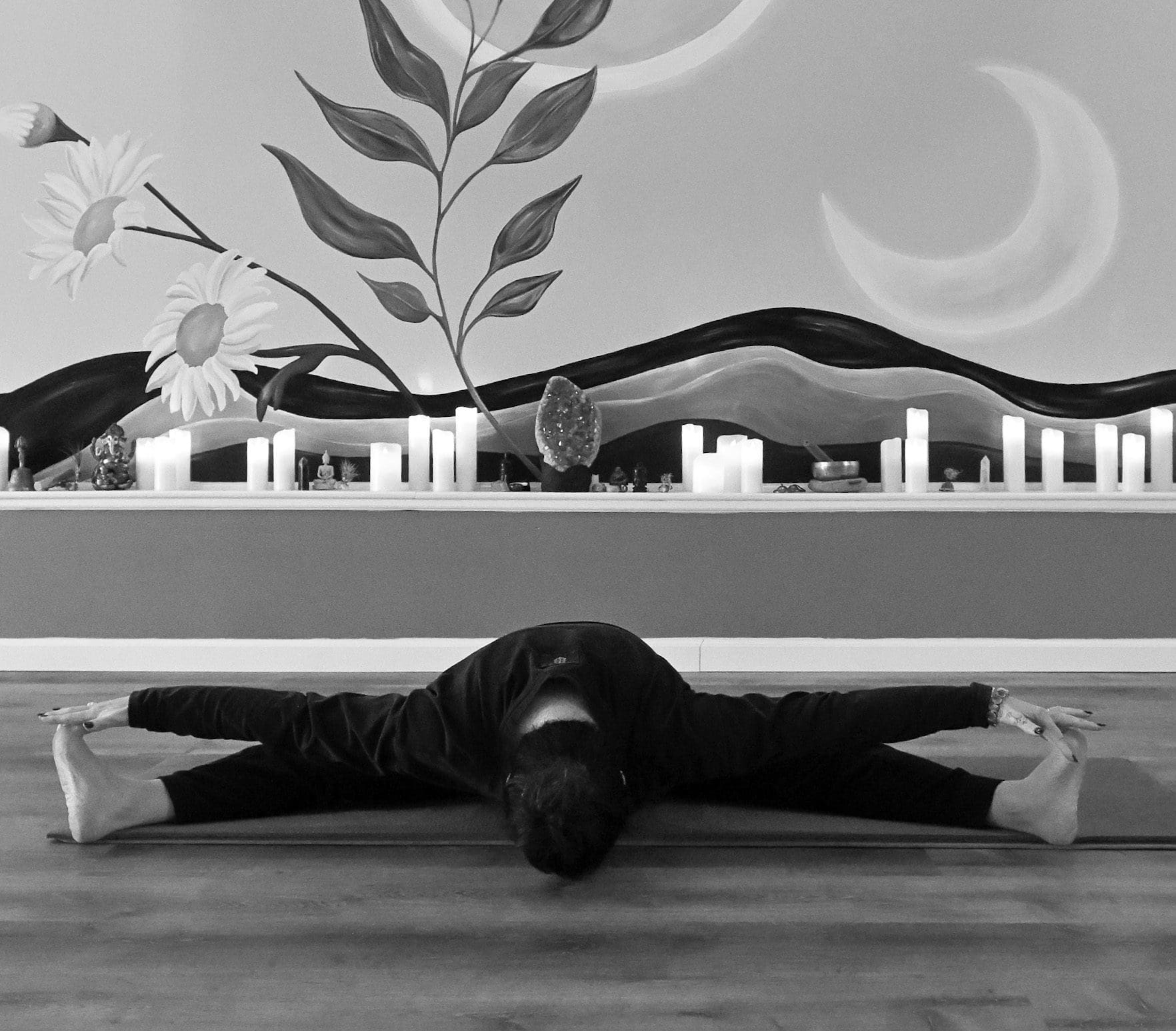 Person in wide-legged forward fold yoga pose