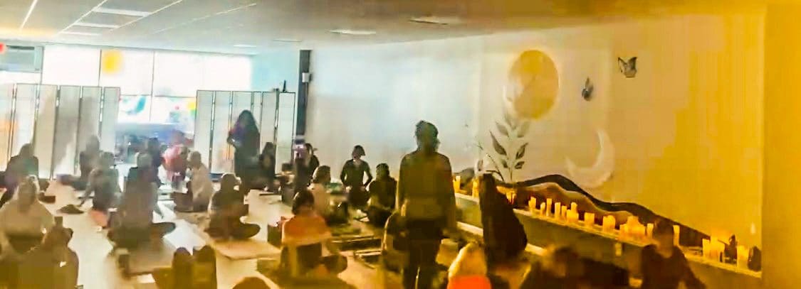 Group meditation class on mats in studio