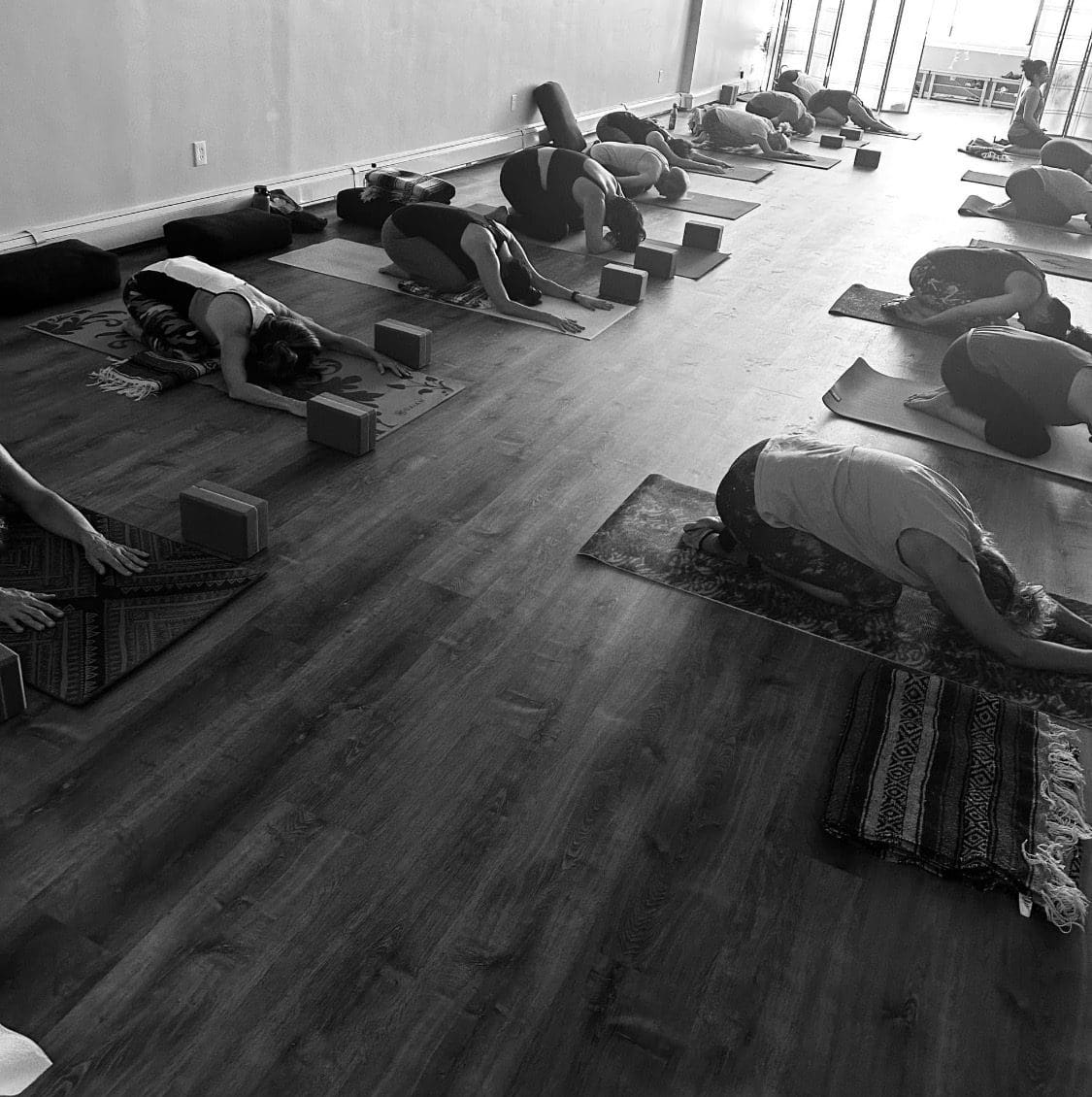 Indoor group yoga class in child's pose