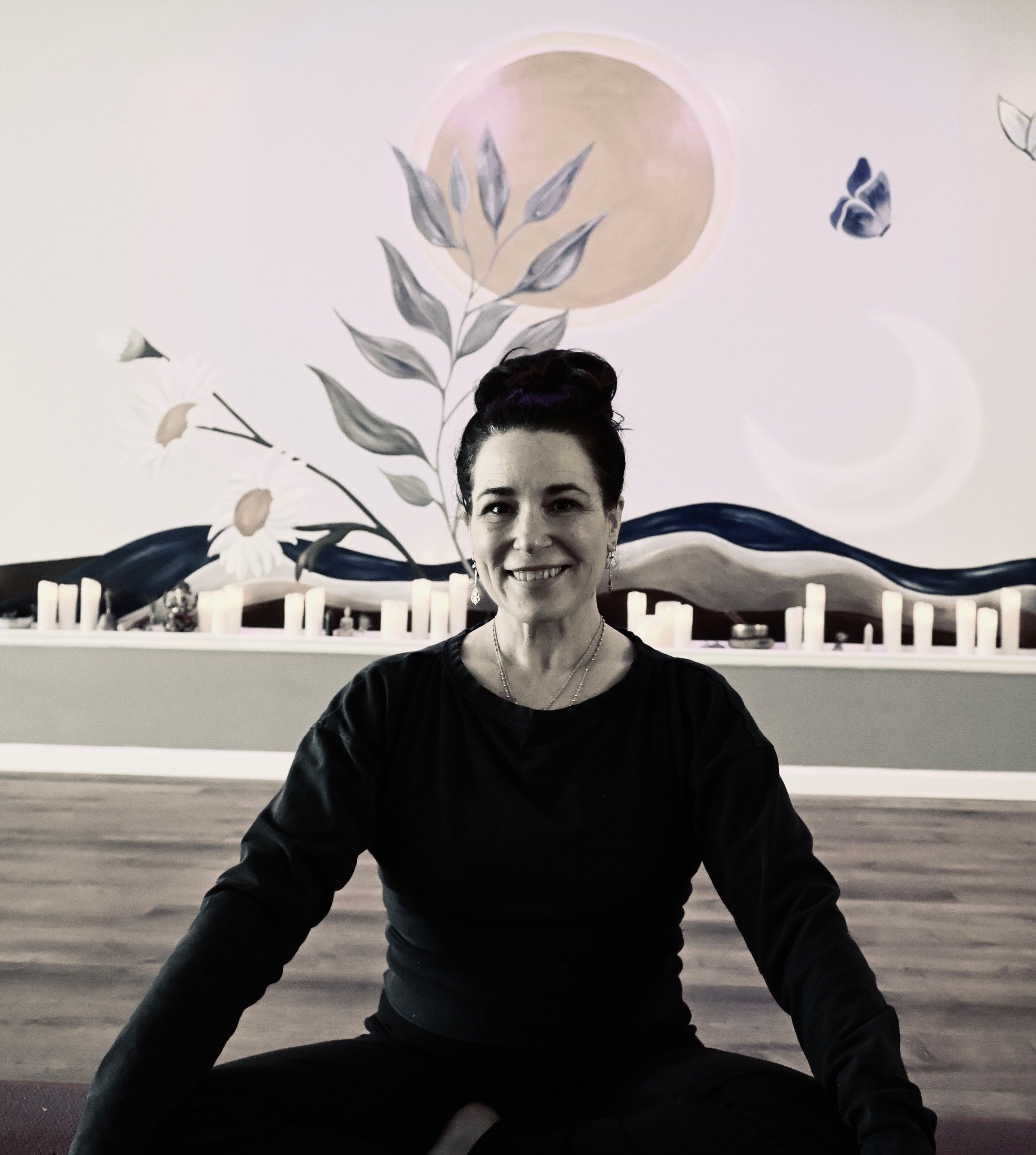 Woman seated cross-legged in yoga studio